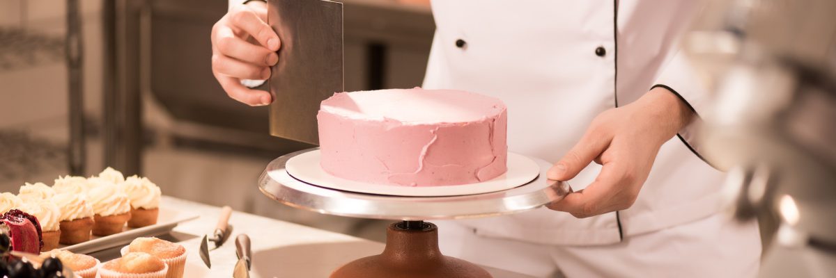 cropped-shot-of-confectioner-making-cake-in-restaurant-kitchen.jpg